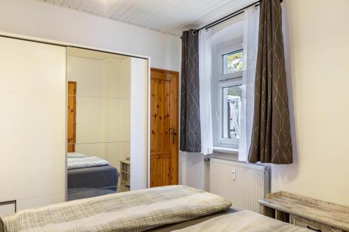 a bedroom with two beds and a mirror at Ferienwohnung Bernoth in Erfurt