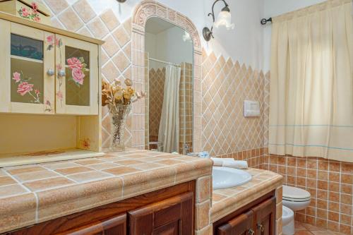 a bathroom with a sink and a toilet at Casa Anna in San Teodoro