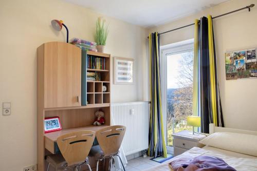 a bedroom with a desk and a bed and a window at Ferienwohnung Tannenblick 8-1 in Oberhof