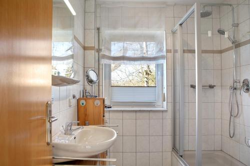 a bathroom with a sink and a shower at Ferienwohnung Tannenblick 8-1 in Oberhof
