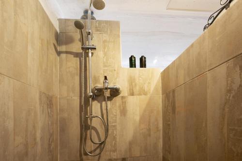a shower in a bathroom with bottles on a wall at Alma Eco-rústico Adults Only in El Charco
