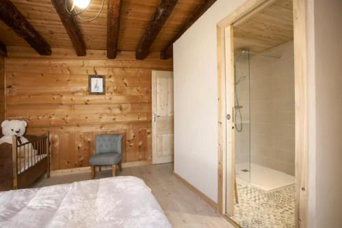 a bedroom with a bed and a glass shower at L'échappée des Rêves in Verchaix