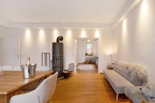 a living room with a couch and a stove at Alte Revierförsterei in Börfink