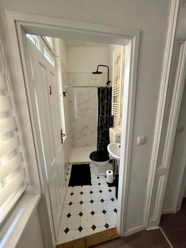a white bathroom with a toilet and a sink at Harmonija26 in Karlovac