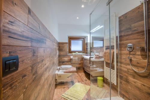 a bathroom with a shower and a toilet and a sink at Apartments Christa App A in Ortisei