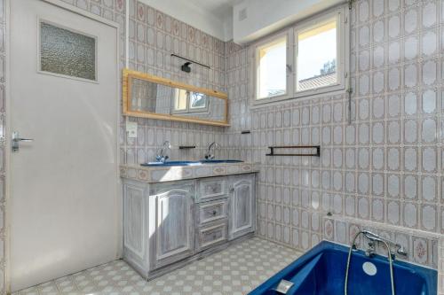 a bathroom with a sink and a mirror at La Baule in La Baule