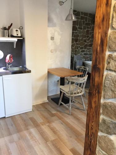 a kitchen and dining room with a table and chairs at Viktória Inn Tihany in Tihany