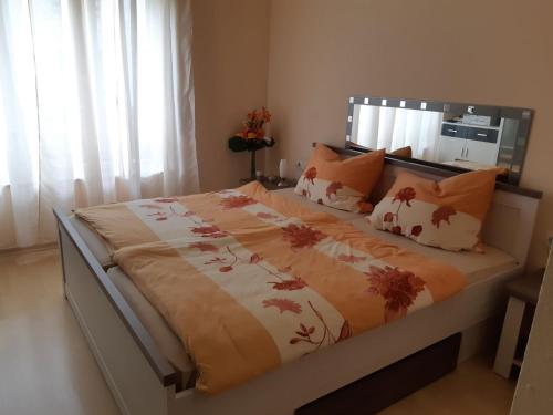 a bedroom with a large bed with a blanket on it at Ferienwohnung Laura in Langenargen