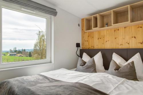 a bedroom with a large bed with a window at Haus Heike in Untergriesbach