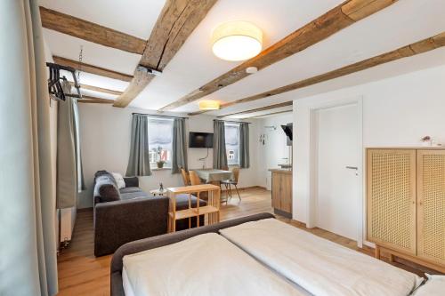 a bedroom with a bed and a living room at Zeihäänger Stubb in Schwalmstadt