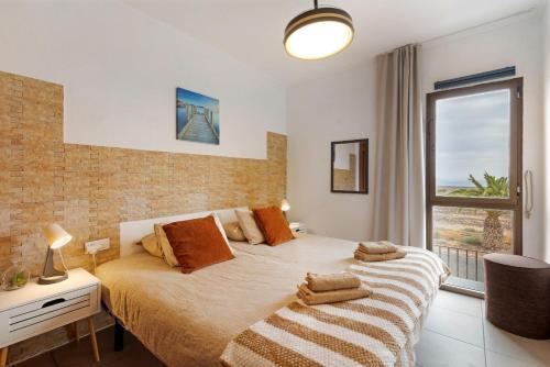 a bedroom with a large bed and a window at Casa Nicole Sea View in Costa de Antigua
