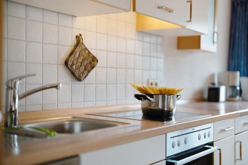 a kitchen with a sink and a counter top at Baschijörgenhof in Sankt Peter