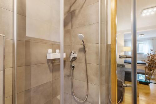 a shower in a bathroom with a glass door at Ferienwohnung Emilia, 36qm in Münsingen