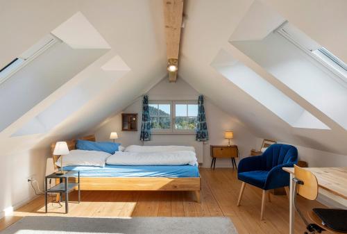 a attic bedroom with a bed and a desk at Gallushof in Lauterbach