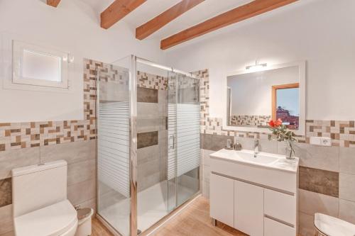 a bathroom with a shower toilet and a sink at Villa Frontera in Sóller
