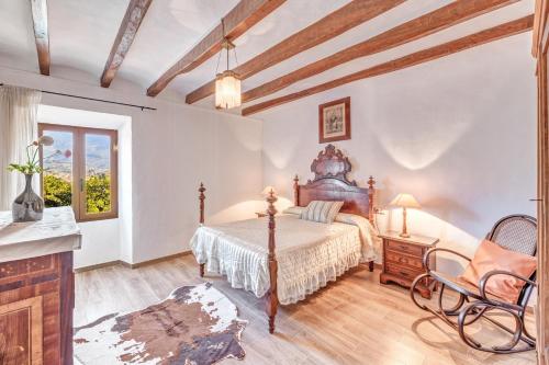 a bedroom with a bed and a table and chairs at Villa Frontera in Sóller