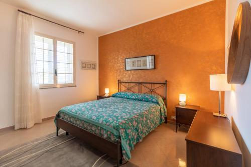 a bedroom with a bed and a window at Villa Bartolomeo in Modica