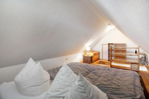 a bedroom with a bed with white pillows at Landhaus Peenemünde in Peenemünde