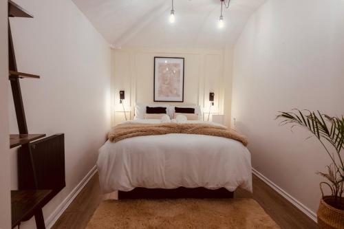 a bedroom with a large bed with white walls at Apartment in cite center in Manchester