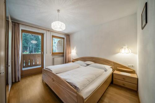 a bedroom with a large bed in a room with a window at Ferienhaus Maria Schneeglöcklein in Moso