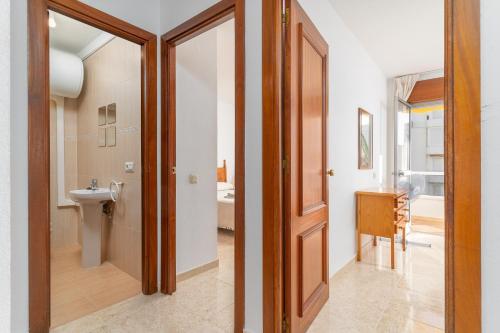 a bathroom with a toilet and a sink at Beach and Pool Laguna Beach A113 in Torrox