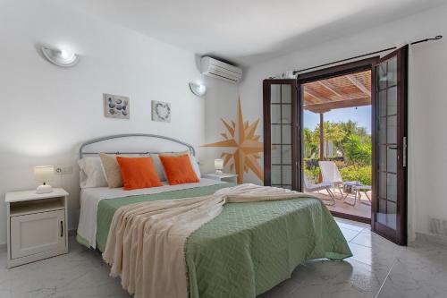 a bedroom with a bed with an open door to a patio at Casa Margarita in Lanzarote