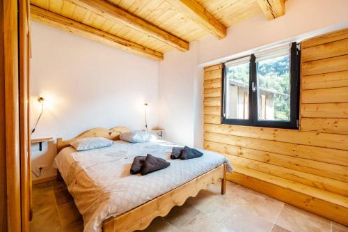 a bedroom with a bed in a room with a window at Agréable Chalet 3 étoiles App 3 in Courchevel