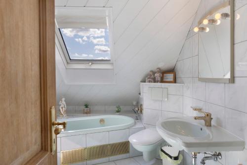 a bathroom with a sink toilet and a tub at Haus Claudia in Fulda