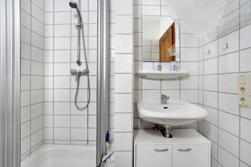 a white bathroom with a sink and a shower at Ferienpark Gustow B09 in Gustow
