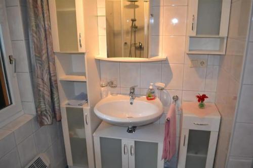 a bathroom with a sink and a mirror at Ferienhaus Waldenstein 1 in Waldenstein