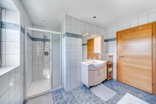 a bathroom with a sink and a shower at Haus Reichl in Berndorf bei Salzburg