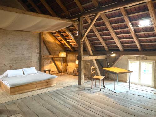 a bedroom with a bed and a desk and a table at Apartments-Schlamau19 in Schlamau