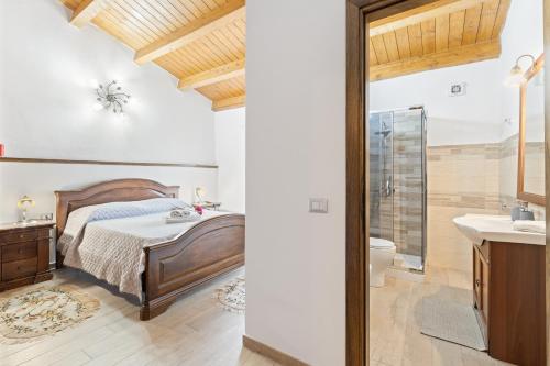 a bedroom with a bed and a shower and a sink at Affittacamere Le Muse in Scano Montiferro