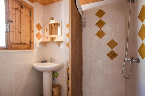 a small bathroom with a sink and a shower at Casa Milita in Tavira