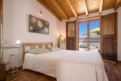 a bedroom with a bed and a view of the ocean at Casa Milita in Tavira
