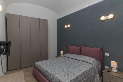 a bedroom with a bed and a wall with lights at Rifla Vacanze in La Maddalena