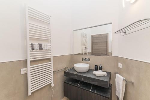 a bathroom with a sink and a mirror at Rifla Vacanze in La Maddalena