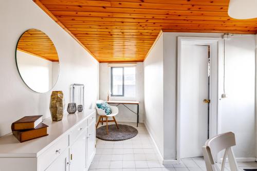 a home office with white cabinets and a wooden ceiling at Casa da Praya in Horta