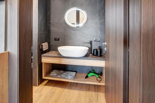 a bathroom with a sink and a mirror at Chalet Kb in Livigno