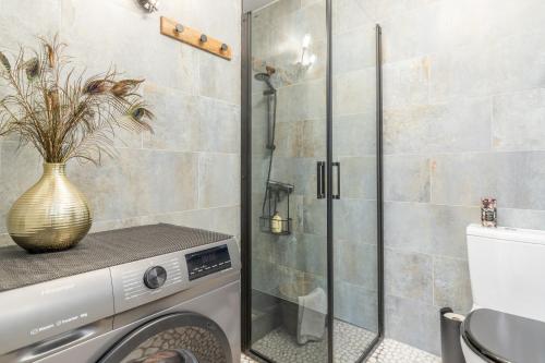 a bathroom with a shower and a washing machine at Casa Sillero Dos in Moraira