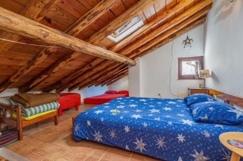 a bedroom with a bed and a wooden ceiling at Casa da Praia 1 in Budens