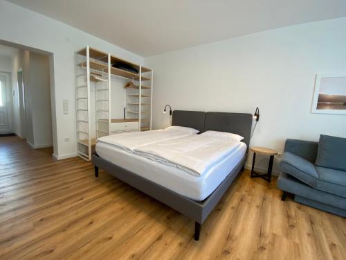a bedroom with a bed and a blue couch at Myzell in Radolfzell am Bodensee