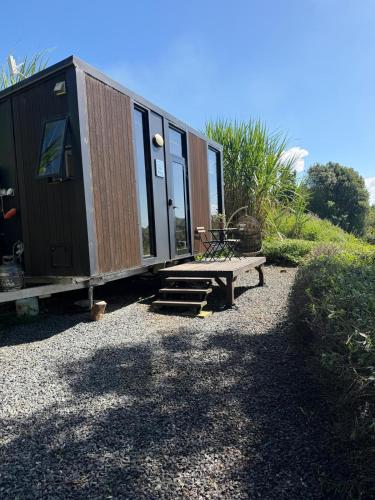 a tiny house sitting on top of a gravel lot at Rosewood Tiny Home by Tiny Away in Federal