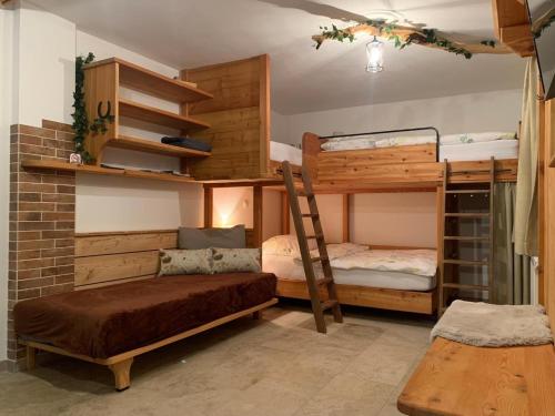 a room with two bunk beds and a bench at Bergchalet Zirbenzapfen in Judenburg