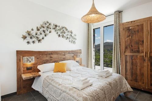 a bedroom with a bed and a large window at Villa Lice - Coronata in Casarza Ligure