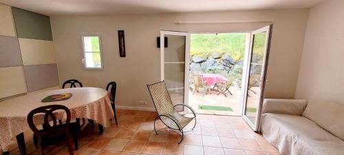 a living room with a table and a couch at La Maison Des Conches - Ref 803 in Longeville-sur-Mer