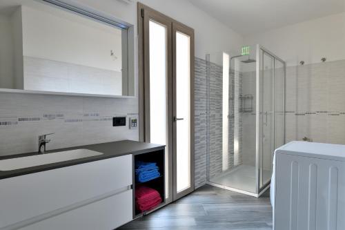 a bathroom with a sink and a shower at Appartamento Latorre in Bari Sardo