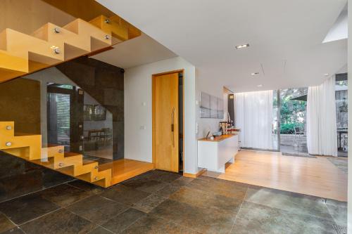 a living room with a staircase in a house at Tróia Villa Paradise in Troia