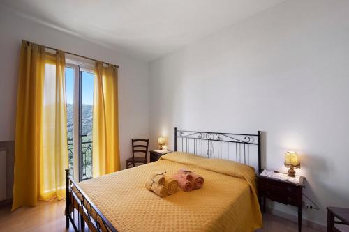 a bedroom with a bed with two teddy bears on it at I Girasoli in Alassio