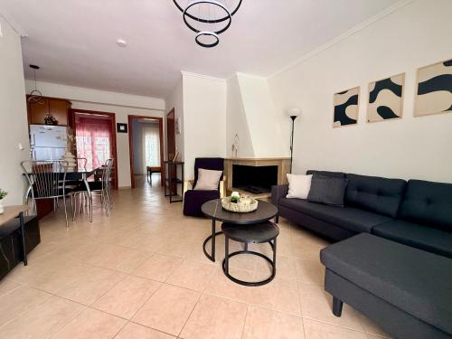 a living room with a couch and a table at Casa d'Angelo by Horizon Homes in Orfánion